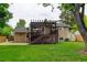 Back exterior featuring a deck with a pergola, a well-maintained lawn, and a charming aesthetic at 8410 Gray St, Arvada, CO 80003