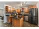 Modern kitchen with a center island, black appliances, and elegant wood cabinetry at 8410 Gray St, Arvada, CO 80003