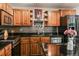 Well-equipped kitchen with granite countertops, stainless steel appliances, and wood cabinets at 8410 Gray St, Arvada, CO 80003