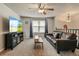 Spacious living room featuring plush carpeting, a leather couch, and a large screen TV at 8410 Gray St, Arvada, CO 80003