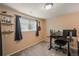 Home office with a desk, computer monitors, shelving, and window allowing for natural light at 8410 Gray St, Arvada, CO 80003