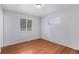 Bright and airy bedroom featuring hardwood floors, with two windows providing ample natural light at 867 S Grape St, Denver, CO 80246