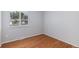 Neutral bedroom with hardwood floors, ample natural light, and a minimalist aesthetic at 867 S Grape St, Denver, CO 80246