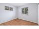 Bright and airy bedroom featuring hardwood floors, with two windows providing ample natural light at 867 S Grape St, Denver, CO 80246