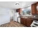 Traditional kitchen with wood cabinets, sleek countertops, and modern white appliances at 867 S Grape St, Denver, CO 80246