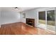 Bright living room featuring hardwood floors, a cozy fireplace, and sliding glass doors to the backyard at 867 S Grape St, Denver, CO 80246