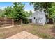 Backyard featuring a level area with a brick pathway, fencing, and small brick patio at 2737 N Marion St, Denver, CO 80205