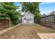 Backyard featuring a level area with a brick pathway, fencing, and small brick patio at 2737 N Marion St, Denver, CO 80205