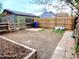 Spacious backyard featuring a wooden fence, a small garden area, and a spot for outdoor seating at 2737 N Marion St, Denver, CO 80205
