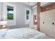 Cozy bedroom featuring exposed brick accent wall, two windows, and light wood flooring at 2737 N Marion St, Denver, CO 80205
