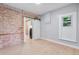 Comfortable bedroom with exposed brick wall, modern sliding door, and natural light at 2737 N Marion St, Denver, CO 80205