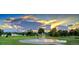Scenic view of Denver City Park with a fountain, lush greenery, and the city skyline in the background at sunset at 2737 N Marion St, Denver, CO 80205