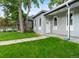 Charming gray home with a well-manicured lawn and a welcoming white front door at 2737 N Marion St, Denver, CO 80205
