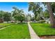 Well-maintained front yard featuring a lush green lawn, sidewalk, mature trees, and street parking at 2737 N Marion St, Denver, CO 80205
