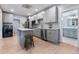 Contemporary kitchen featuring gray cabinetry, stainless steel appliances, and a charming central island at 2737 N Marion St, Denver, CO 80205
