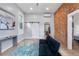 Inviting living area featuring an exposed brick wall and a contemporary futon and decor at 2737 N Marion St, Denver, CO 80205