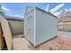 Exterior shot of a gray storage shed with a side door and a concrete slab at 2737 N Marion St, Denver, CO 80205