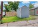 Exterior shot of a gray storage shed with partial view of fence and truck at 2737 N Marion St, Denver, CO 80205