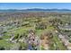 Aerial view of the home and surrounding neighborhood, showcasing the community and mountain views at 9998 W 70Th Pl, Arvada, CO 80004