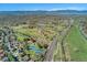 Aerial view showcasing the neighborhood, a park, a lake and mountain views in the distance at 9998 W 70Th Pl, Arvada, CO 80004