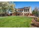 Large backyard featuring a deck, patio with furniture, and mature tree, great for entertaining and relaxing at 9998 W 70Th Pl, Arvada, CO 80004
