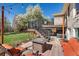 Exterior view of the backyard with outdoor furniture, mature trees and grass lawn at 9998 W 70Th Pl, Arvada, CO 80004