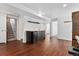 Spacious basement area with wood floors, wet bar with mini fridge, and access to the stairs at 9998 W 70Th Pl, Arvada, CO 80004