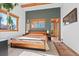 Primary bedroom featuring a large bed and windows at 9998 W 70Th Pl, Arvada, CO 80004