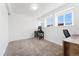 Bedroom with three windows, neutral carpet, desk, chair, and closet at 9998 W 70Th Pl, Arvada, CO 80004