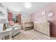 Comfortable Bedroom with pink accent wall and modern decor at 9998 W 70Th Pl, Arvada, CO 80004