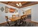 Dining room with hardwood floors, wood plank ceiling, and modern decor at 9998 W 70Th Pl, Arvada, CO 80004