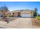 Charming single-story home with brick facade, well-maintained landscaping, and a two-car garage at 9998 W 70Th Pl, Arvada, CO 80004