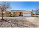 Charming single-story home with brick facade, well-maintained landscaping, and a two-car garage at 9998 W 70Th Pl, Arvada, CO 80004