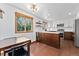 Modern kitchen featuring white cabinets, stainless steel appliances, and a butcher block island at 9998 W 70Th Pl, Arvada, CO 80004
