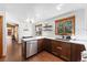 Well-lit kitchen featuring stainless steel appliances, a large sink, and ample counter space at 9998 W 70Th Pl, Arvada, CO 80004
