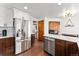Bright kitchen features stainless steel appliances, white cabinets, and hardwood floors at 9998 W 70Th Pl, Arvada, CO 80004