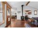 Cozy living room with hardwood floors, a wood-burning stove, and an open view to the kitchen at 9998 W 70Th Pl, Arvada, CO 80004