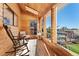 Cozy sunroom with wooden walls, rocking chair, and lots of windows at 9998 W 70Th Pl, Arvada, CO 80004
