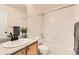 This is a full bathroom with a shower and tub combination, a marble countertop, and a wood vanity at 1842 Reliance Cir, Superior, CO 80027
