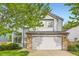 Beautiful two-story home featuring light blue siding, brick accents, mature trees, and a two car garage at 1842 Reliance Cir, Superior, CO 80027