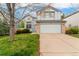 Charming two-story home with attached two car garage, manicured lawn, and mature tree at 1842 Reliance Cir, Superior, CO 80027