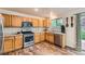 Charming kitchen equipped with modern stainless steel appliances and wood cabinets at 1842 Reliance Cir, Superior, CO 80027