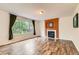 Cozy living room with large window, modern fireplace and wood floors at 1842 Reliance Cir, Superior, CO 80027