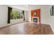 Living room with fireplace and large window offering serene backyard views and natural light at 1842 Reliance Cir, Superior, CO 80027