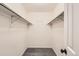 This is an empty walk-in closet with shelving and a neutral color palette and gray carpet at 1842 Reliance Cir, Superior, CO 80027