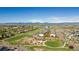 Beautiful aerial view of a community park, playground, and residential area with mountain views at 381 Rainbow Ln, Lafayette, CO 80026