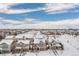 Aerial view of a neighborhood covered in snow with clear blue skies above on a sunny day at 381 Rainbow Ln, Lafayette, CO 80026