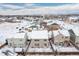 Winter aerial view of a residential neighborhood showcasing snow-covered houses and tree-lined streets at 381 Rainbow Ln, Lafayette, CO 80026