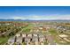 Scenic aerial shot of a community featuring homes, green spaces, a playground, and mountain views at 381 Rainbow Ln, Lafayette, CO 80026