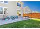 Spacious backyard featuring a concrete patio with stylish outdoor seating and a well-maintained lawn at 381 Rainbow Ln, Lafayette, CO 80026